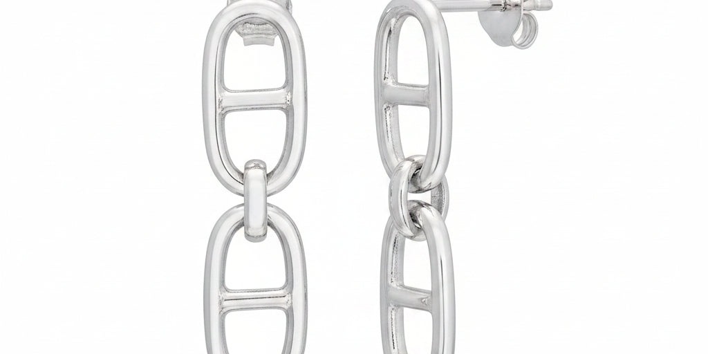 A pair of polished silver drop earrings featuring a vertical oval link design on one earring and a side profile of the other on a clean white background.